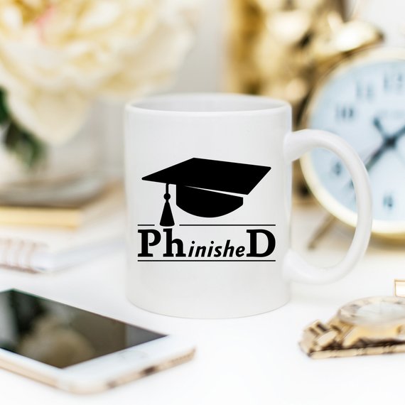 PhinisheD 11oz Coffee Mug featuring a humorous design, perfect for coffee lovers and graduates.